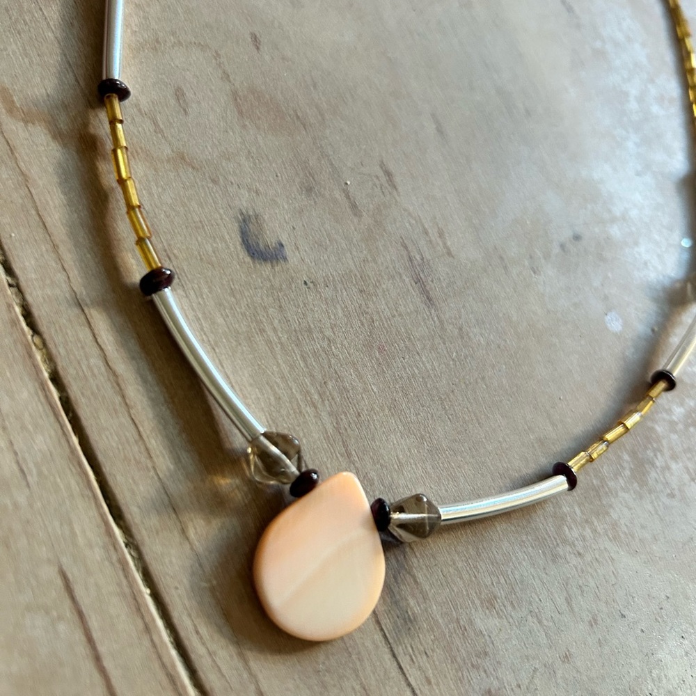 Silver straw and beads necklace with a teardrop shaped mother of pearl